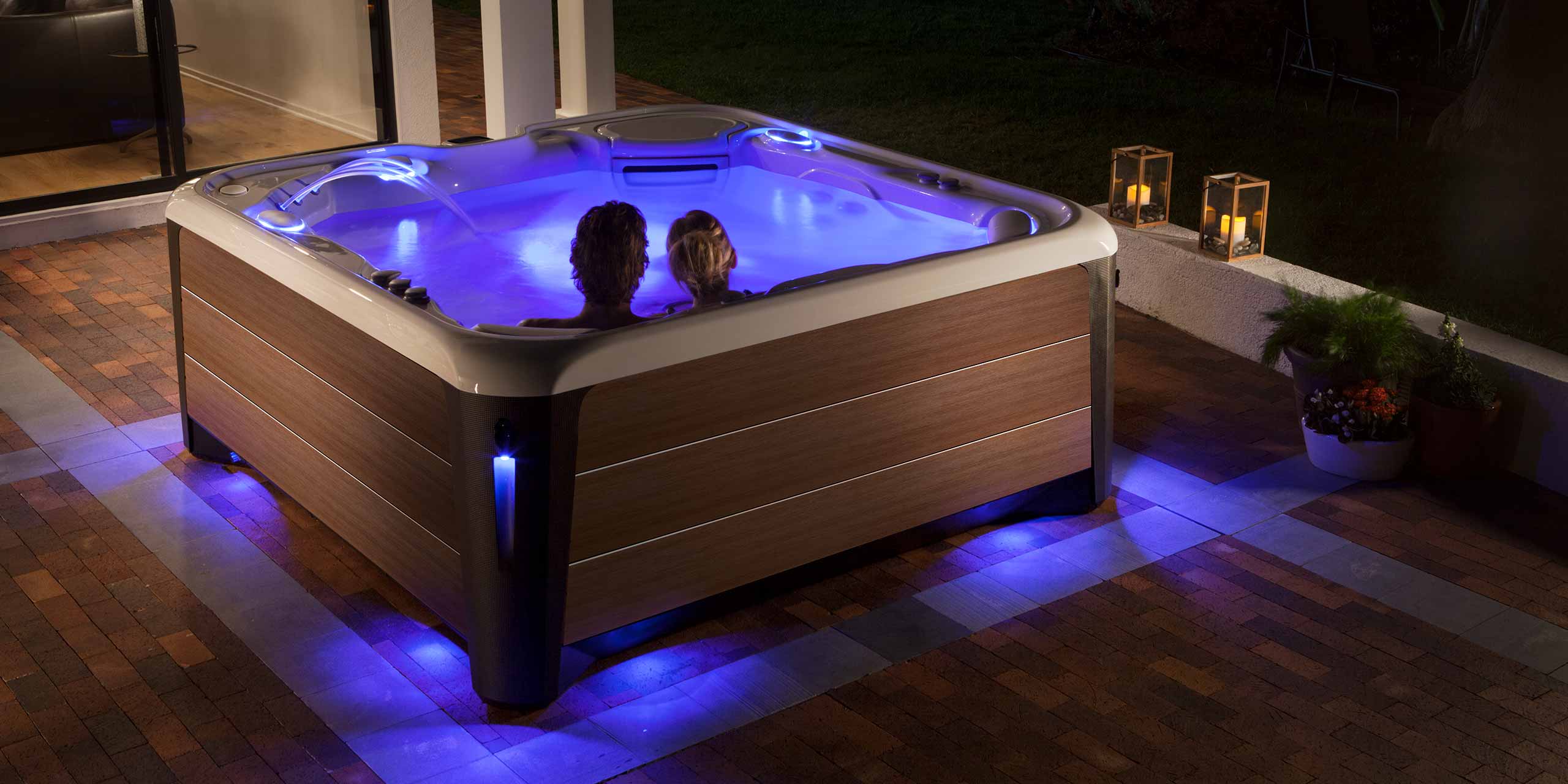 a couple at night enjoying a hot tub