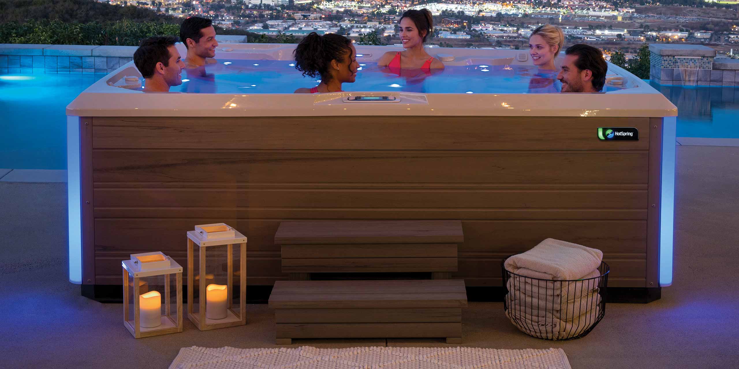 6 people enjoying hot tub at night