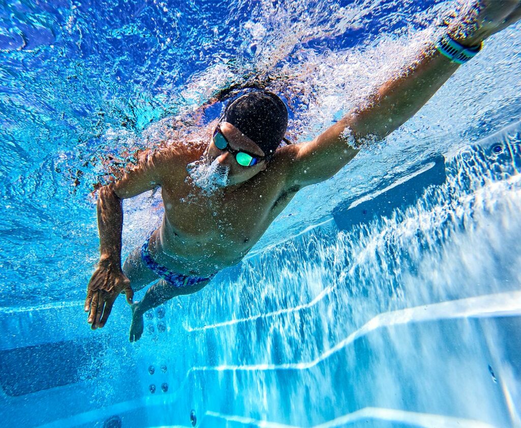 man swimming in a swim spa