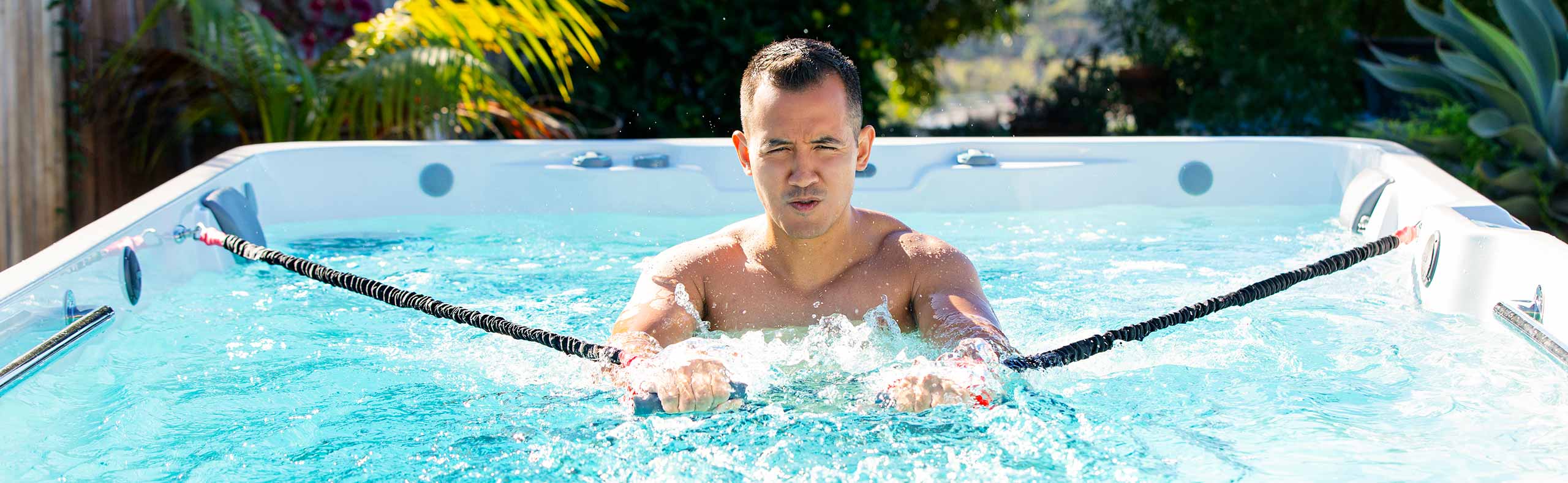man exercising in a swim spa