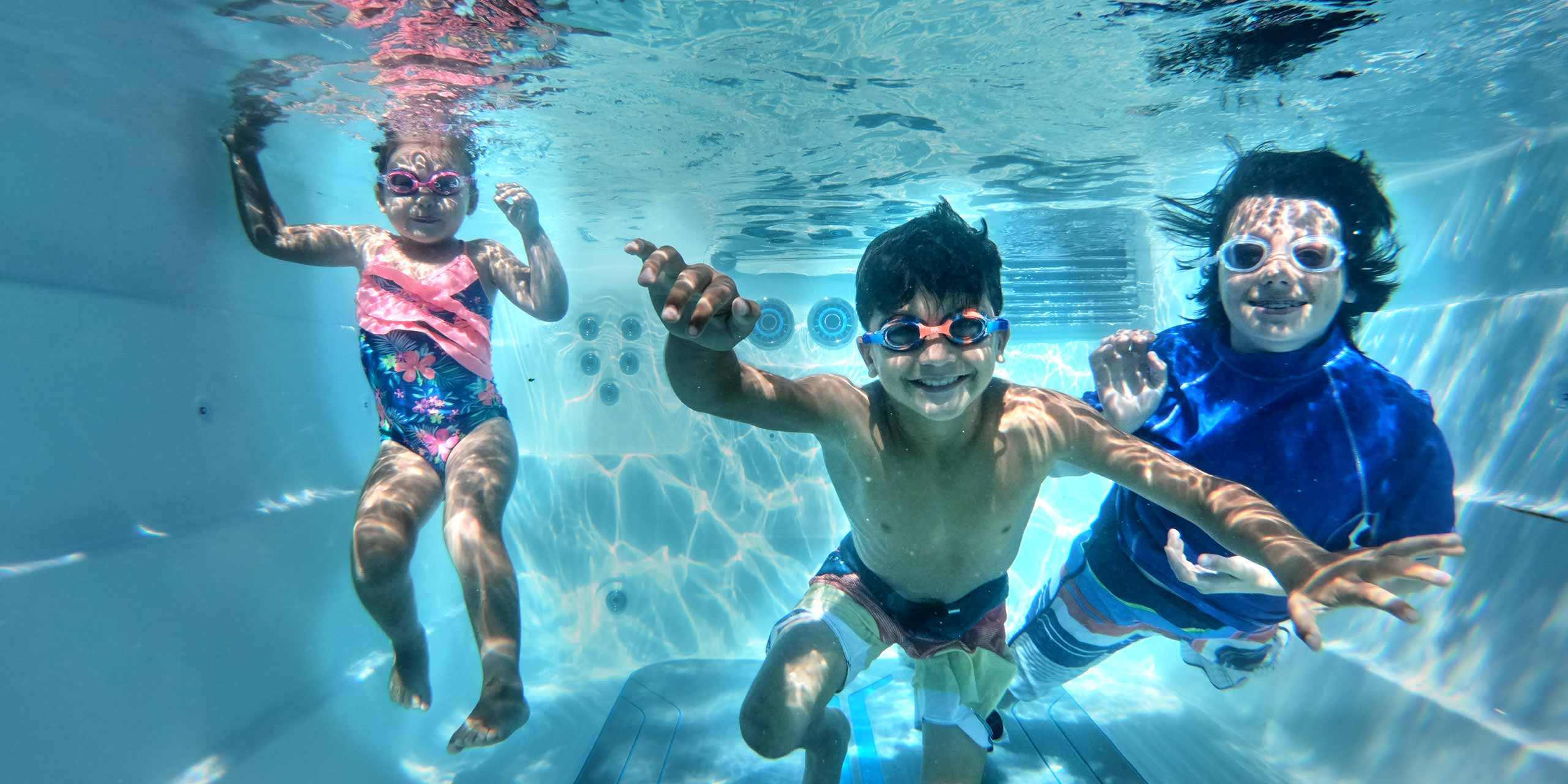 kids playing underwater in a swim spa