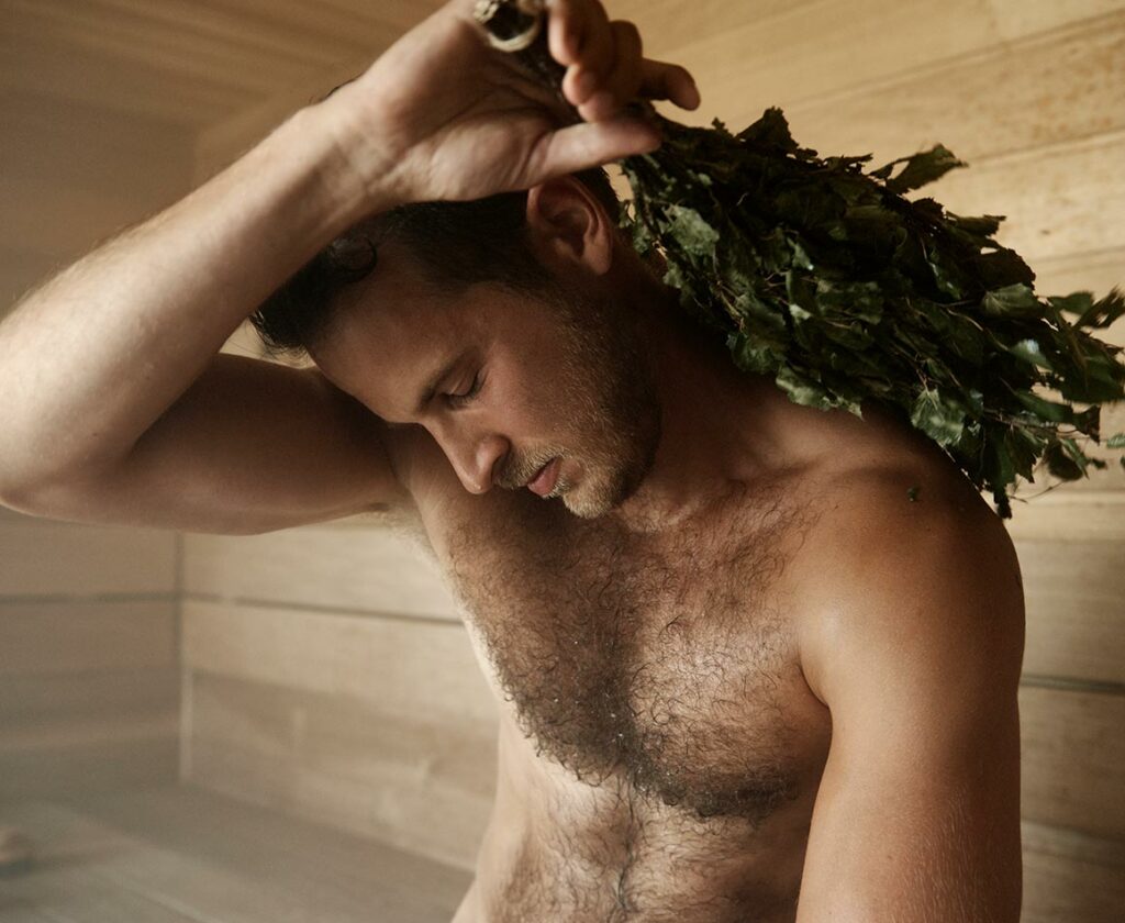 man in a sauna using eucalyptus sauna whisk