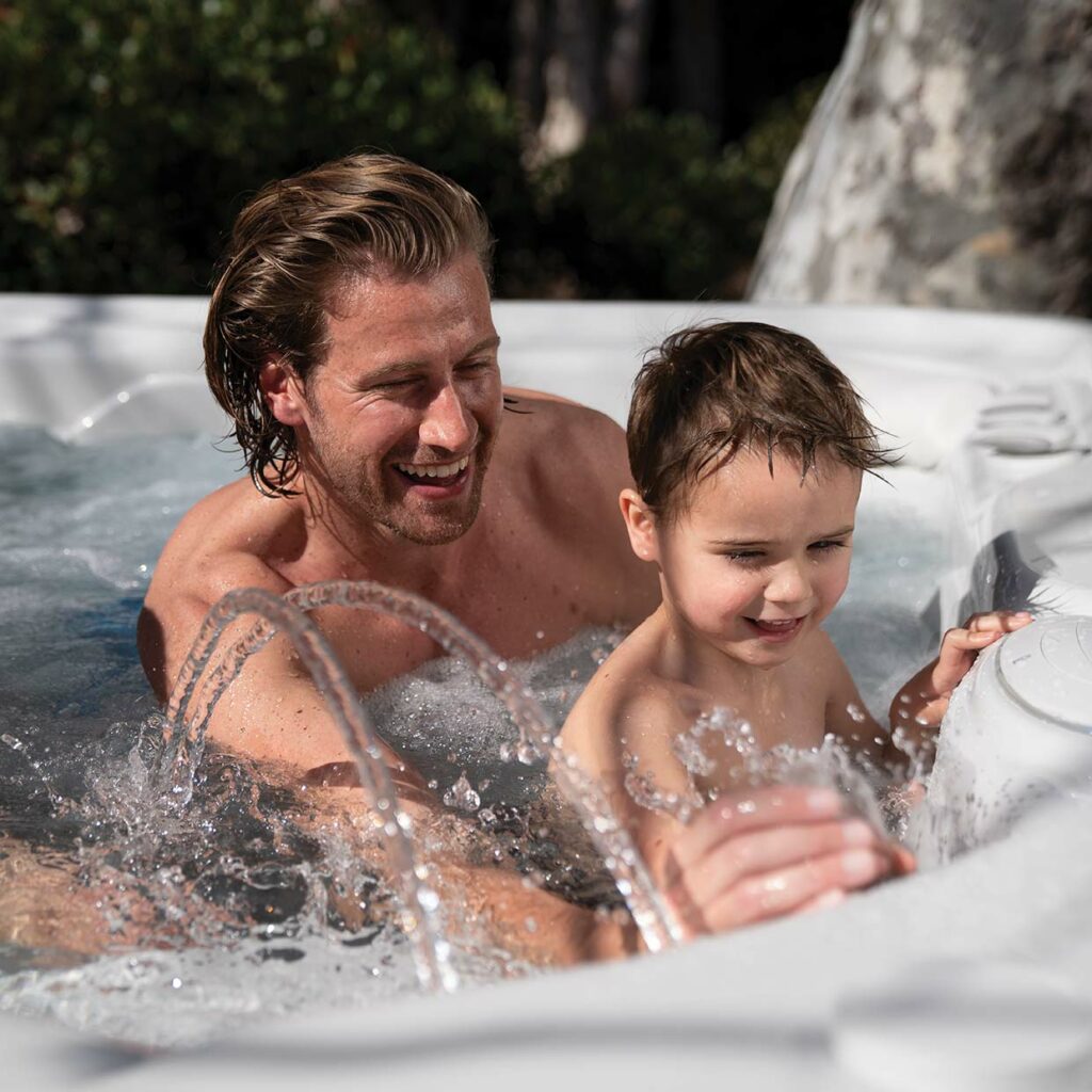 dad and kid in a hot tub