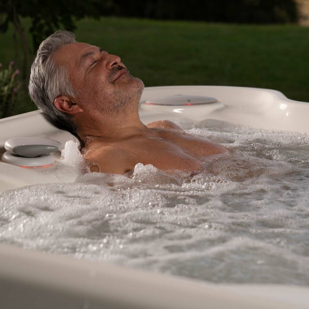 man relaxing in a hot tub