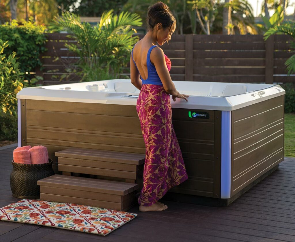 woman standing next to hot tub