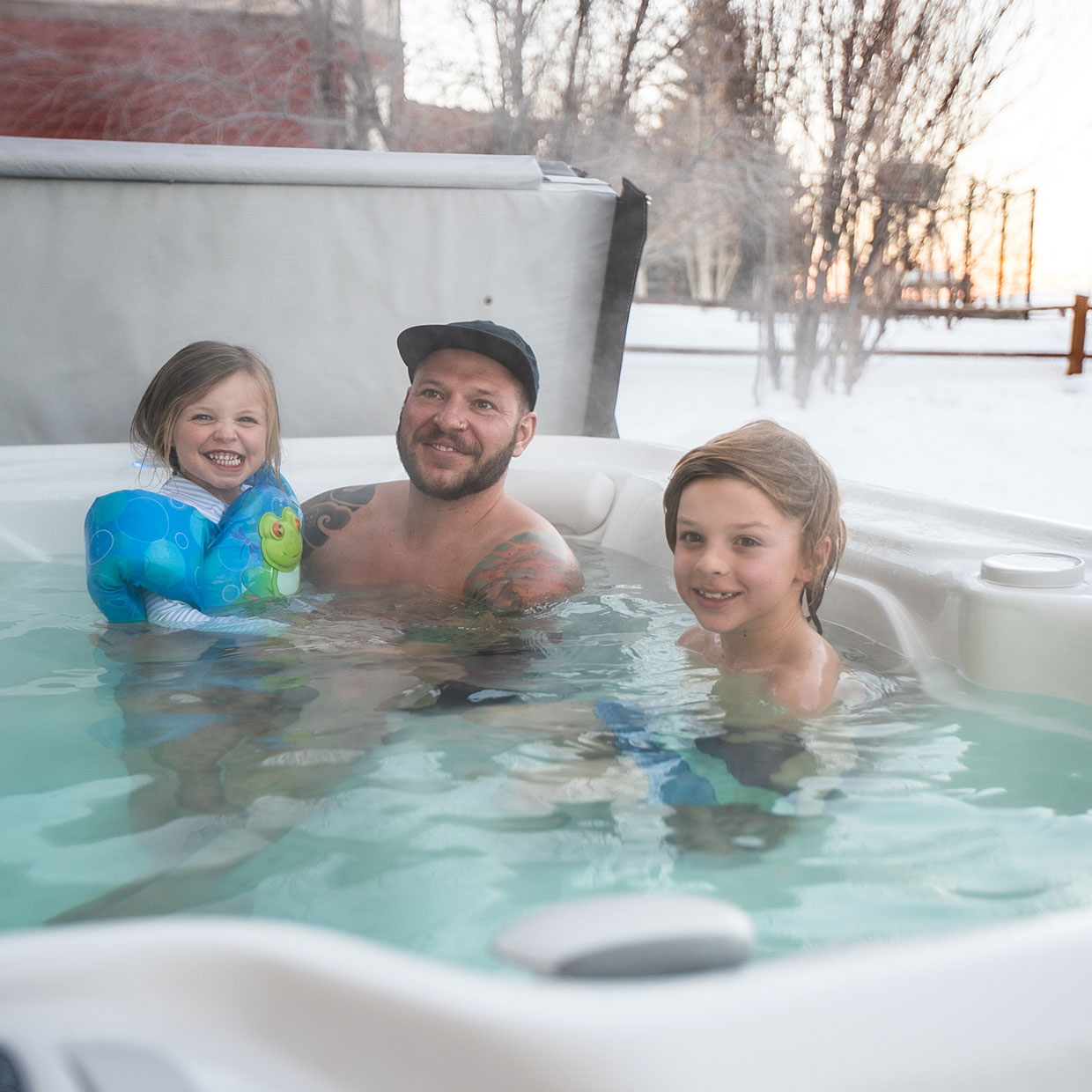 family in a hot tub in winter